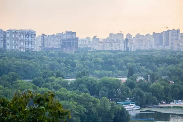 Tour of Kiev in the center of Europe. View of the Dnieper, Trukhanov island and a foot bridge. Park fountain and sunset on the horizon