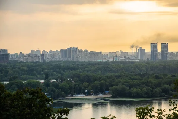 Tour of Kiev in the center of Europe. View of the Dnieper, Trukhanov island and a foot bridge. Park fountain and sunset on the horizon