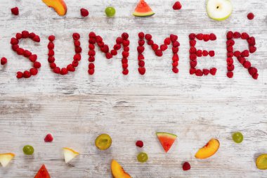 Ahududu meyveleri dokulu bir ışık ahşap arka plan üzerinde yazıt yaz. Dilim meyve, elma, şeftali, kavun, karpuz, üzüm, Erik. Düz üst görünümü, metin için yer. Yat, alanı Kopyala.