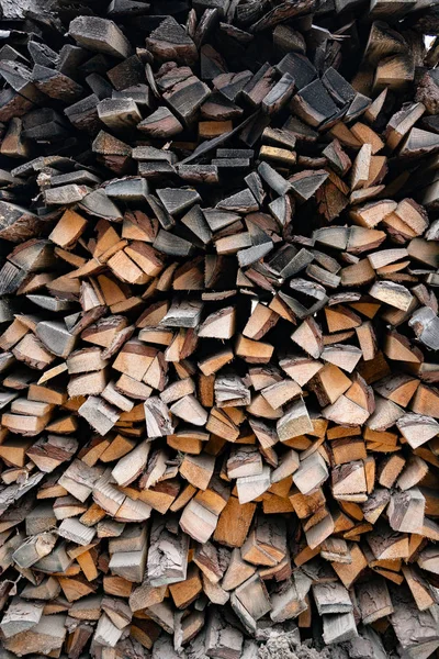 A pile of firewood, sawn timber production waste. Raw materials for the fireplace, stove.