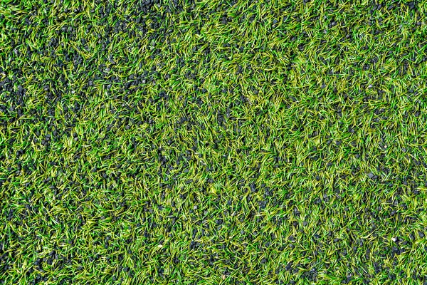 Sports background. Artificial lawn pattern of the stadium. Texture of the combined artificial football field. Copy space, top view, space for text.
