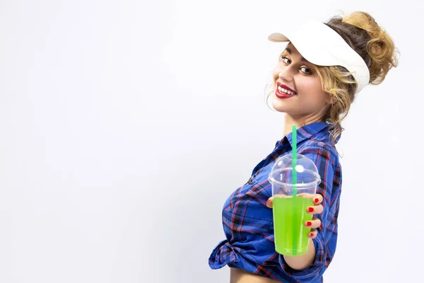 Youth Ideas and Concepts.Closeup of Enticing Caucasian Female in Checked Shirt Offering Green Cocktail Towards Viewer. Against White Background.Horizontal Image