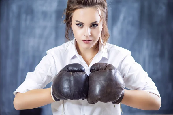 Portrait of Caucasian Female Boxer Posing in Brown Leather Boxer Gloves Against Blackboard. Horizontal Image