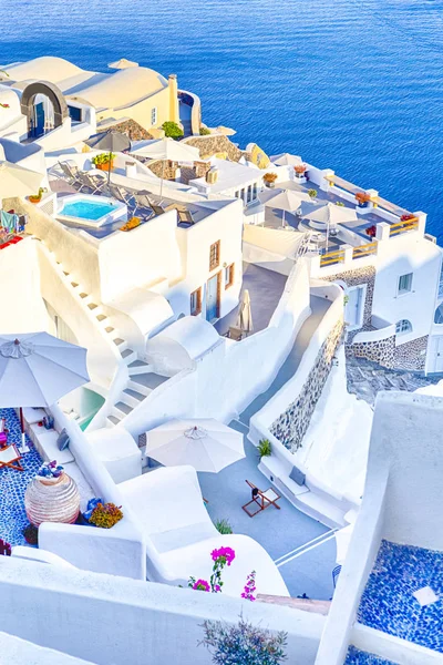 European Destinations. Amazing View of Classic White Houses and Blue Colors of Oia Village Houses And Architecture on Santorini Island in Greece. Vertical Image