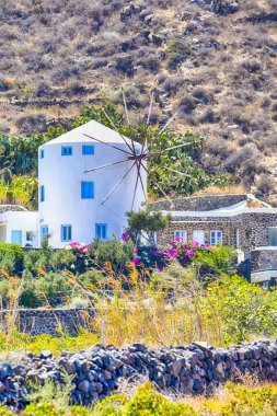 Klasik Yunan Rüzgar Mill Houses Santorini Adası'nda Caldera dağlar üzerinde yuvarlak. Dikey görüntü yönü