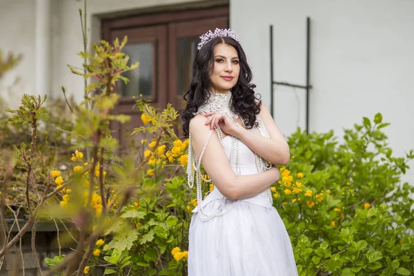 Sensual and Sexy Caucasian Bride With Diadem Posing In Flowers