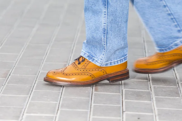 Close-up of Male Legs In Leather Brown Oxford Semi Brogues Shoes