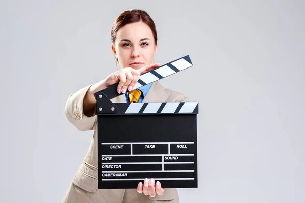 Cinema Concepts and Ideas. Portrait of Female Film Director Posing with Actioncut. Against Gray Background. Horizontal Image Composition