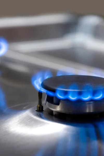 Macro Shoot of Two Gas Burners on Stove Surface with Flames. Vertical Image Composition