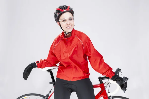 Sport Concepts. Portrait of Positive Female Road Cyclist Posing With Modern Race Bike Against White Background. Horizontal Image