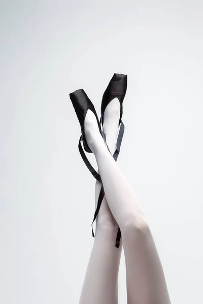 Ballet Dancer Legs In Laced Pointes Shoes. Posing With Straight and Crossed Legs. Vertical Image Composition