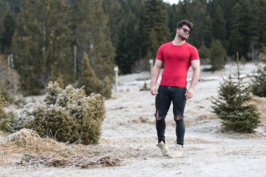 Siyah kot - kaslı atletik vücut Fitness Model açık havada - bir yer, metniniz için poz giyen süre ayakta güçlü kasların esneme sağlıklı genç adam