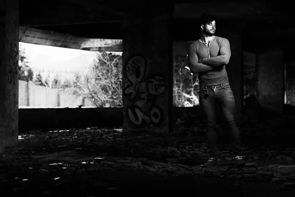 Young Fit Handsome Adult Urban Stylish Man Posing in Front of Graffiti Wall