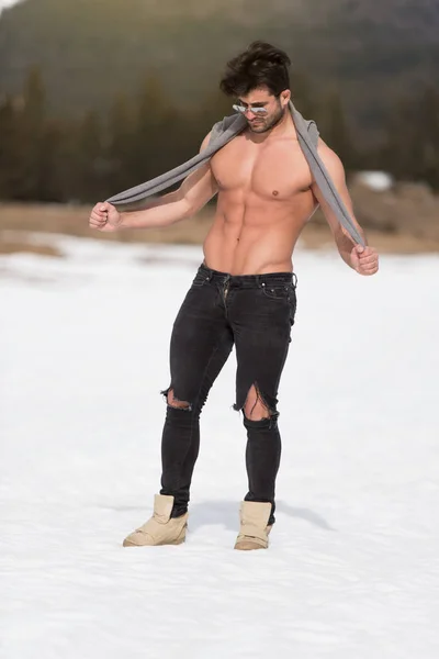 Portrait of a Young Physically Fit Man Showing His Well Trained Body While Wearing Black Jeans - Muscular Athletic Bodybuilder Fitness Model Posing Outdoors - a Place for Your Text