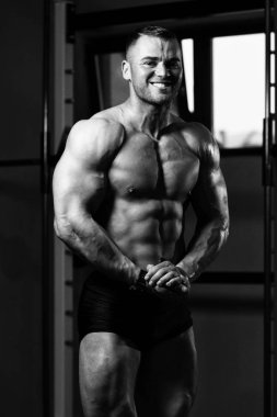 Spor Salonunda Güçlü Duran Genç Adam - Kas Atletik Vücut Geliştirici Spor Sonrası Spor Pozisyonu