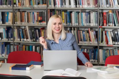 Kütüphanede - kız öğrenci bir alan lise - Üniversite Kütüphanesi - sığ derinliği çalışma kitapları ile güzel