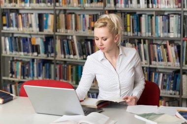 Kütüphanede - kız öğrenci bir alan lise - Üniversite Kütüphanesi - sığ derinliği çalışma kitapları ile güzel