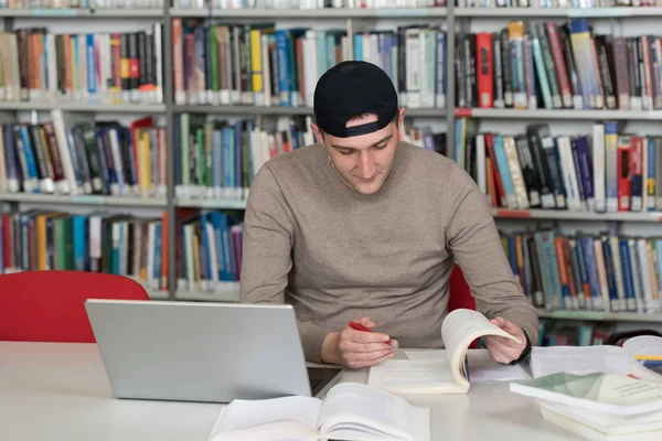 Man Student Cap Working Laptop Books High School Library — Stock Photo, Image