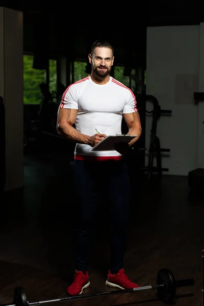 Personal Trainer Takes Notes Clipboard Fitness Center Gym — Stock Photo, Image