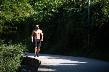 Yakışıklı Sakallı Adam Güçlü Duruyor ve Dışarda Pozisyon Veriyor Yaprakların Arkaplan Doğası