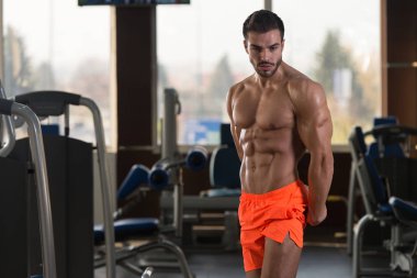 Spor Salonunda Güçlü Duran Genç Adam - Kas Atletik Vücut Geliştirici Spor Sonrası Spor Pozisyonu