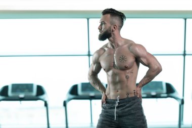 Spor Salonunda Güçlü Duran Genç Adam - Kas Atletik Vücut Geliştirici Spor Sonrası Spor Pozisyonu