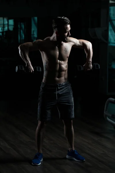 Atleta Haciendo Ejercicio Hombros Con Sombrillas Gimnasio —  Fotos de Stock