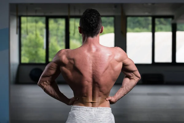 Portrait Of A Young Physically Fit Man Showing His Well Trained Body - Muscular Athletic Bodybuilder Fitness Model Posing After Exercises