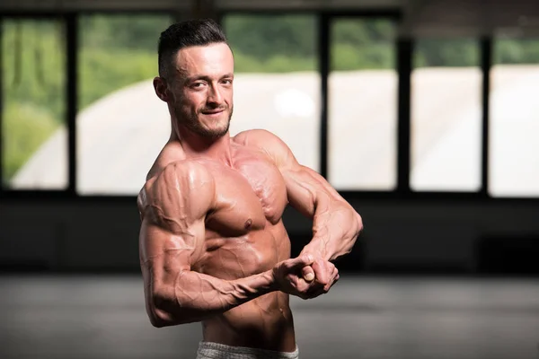 Handsome Young Man Standing Strong Gym Flexing Muscles Muscular Athletic — Stock Photo, Image