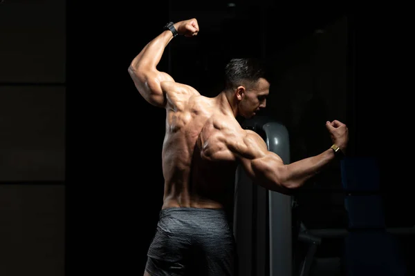 Muscular Man Flexing Muscles Rear Double Biceps Pose — Stock Photo, Image