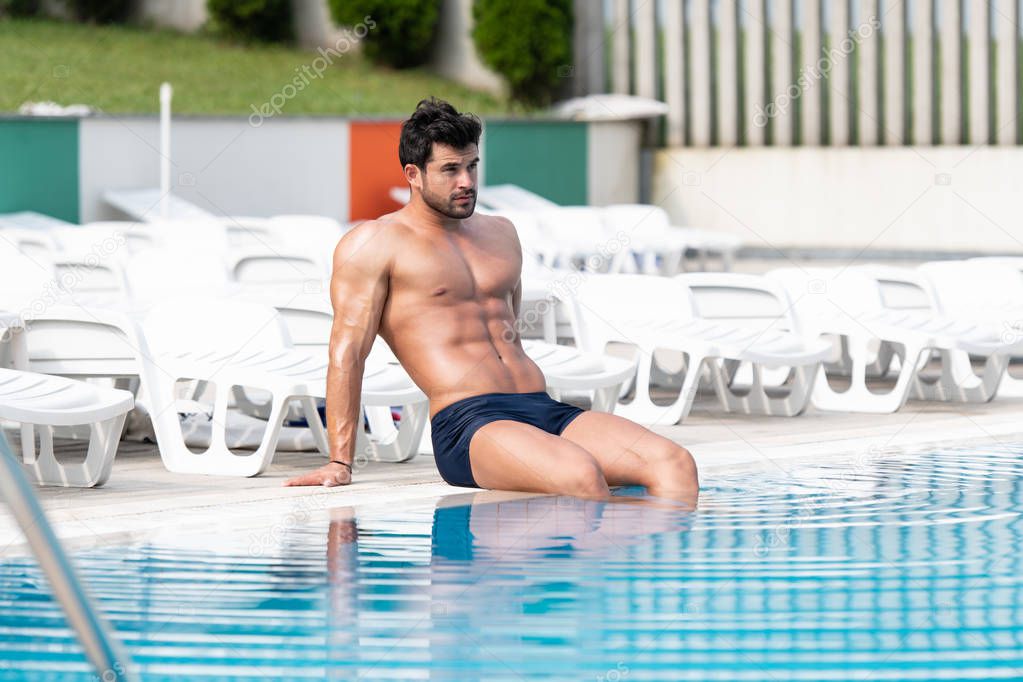 Portrait Of A Muscular Man At Swimming Pool