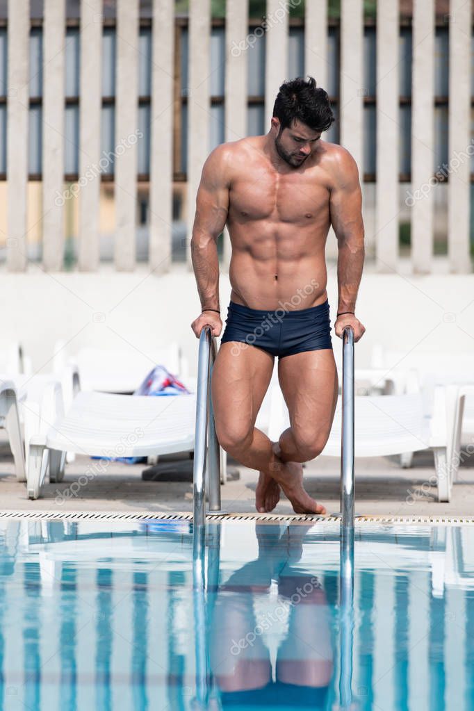 Young Muscular Man At Swimming Outdoor Pool