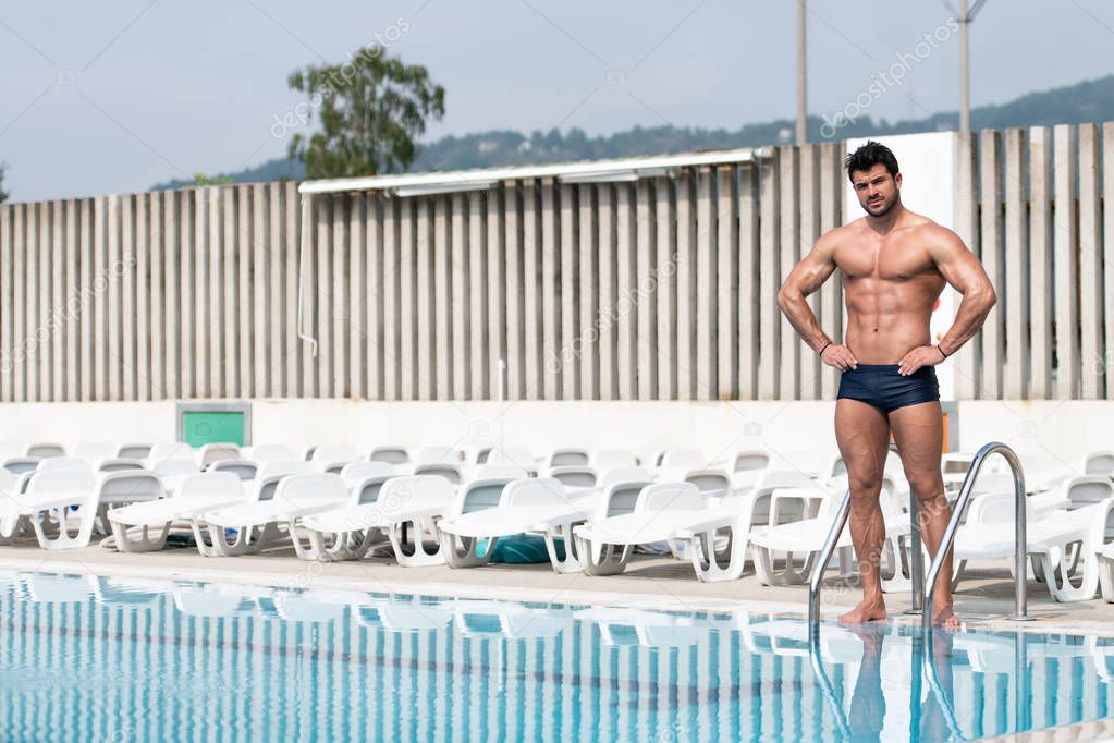 Young Muscular Man At Swimming Outdoor Pool