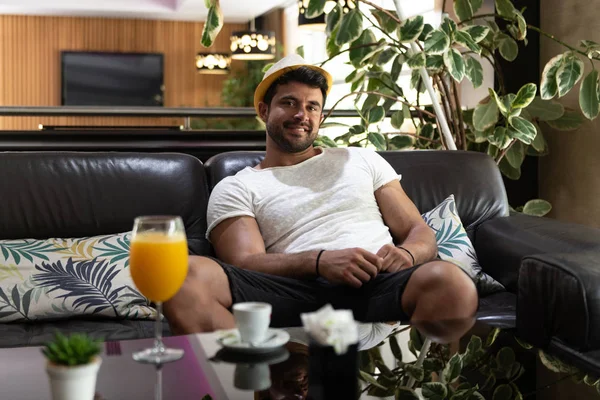 Mann entspannt sich auf Sofa in Hotellobby-Bar — Stockfoto