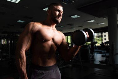 Pazı egzersiz bir spor salonunda Dumbbells ile
