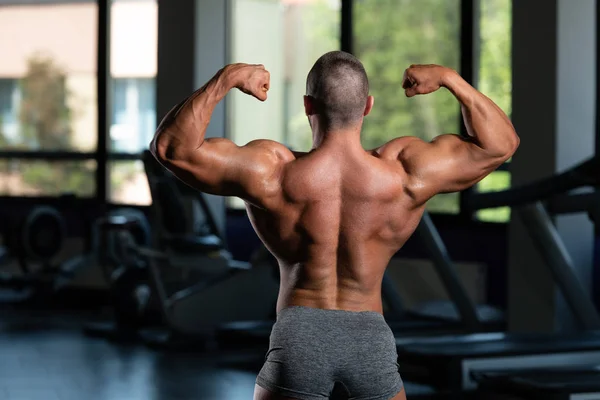 Muskulöse Männer schlagen hinteren doppelten Bizeps Pose — Stockfoto