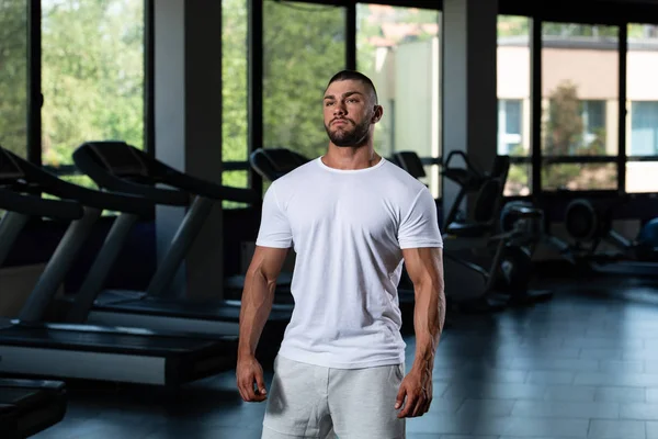 Muskularny Człowiek pozowanie w białym T-shirt — Zdjęcie stockowe