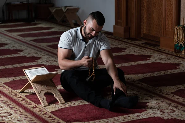 Hombre musulmán leyendo el Sagrado Libro Islámico Corán — Foto de Stock