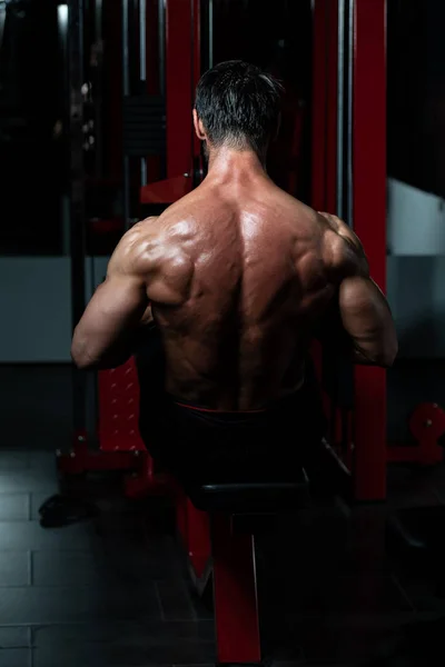 Mature Man Exercising Back On Machine — Stock Photo, Image