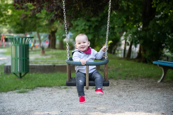 Happy Laughing Toddler Boy Having Fun Swing Enjoying Day Playground — стоковое фото