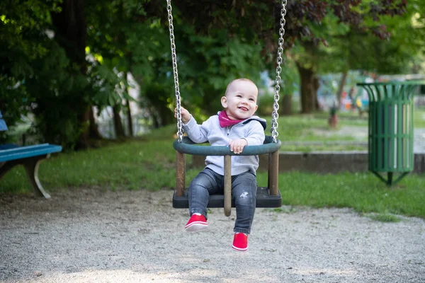 Happy Laughing Toddler Boy Having Fun Swing Enjoying Day Playground — стоковое фото