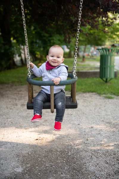 Happy Laughing Toddler Boy Having Fun Swing Enjoying Day Playground — стоковое фото