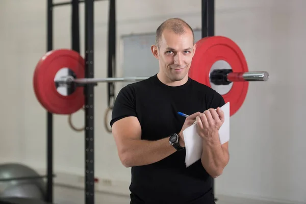 Personal Trainer Takes Notes Clipboard Fitness Center Gym — Stock Photo, Image