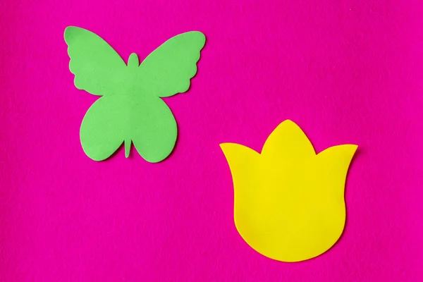 Green butterfly and yellow flower made of soft material on fuchsia background — Stock Photo, Image