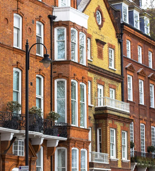 Luxury brick house with white windows in quiet area in central London. Apartments on the banks of the Thames.