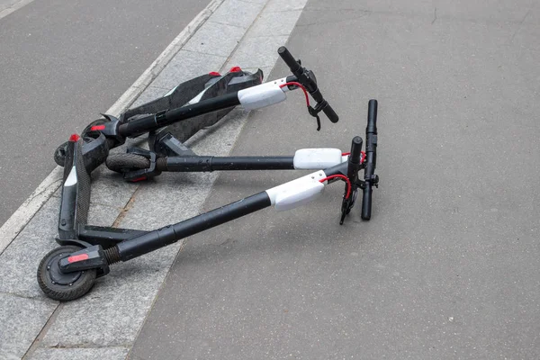 Scooter pateando compartiendo tumbado en la acera. Alquiler eléctrico patinete scooter en París ciudad . — Foto de Stock