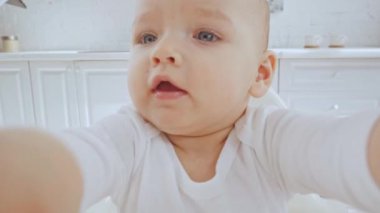 duygusal sevimli çocuk sandalyesinde oturan ve oyuncak küre ile oynuyor