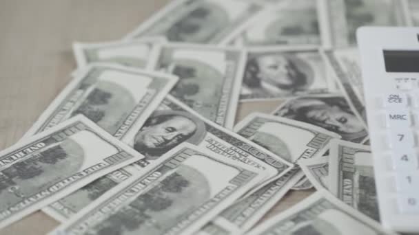 Selective Focus Scattered Dollar Banknotes Calculator Wooden Desk — Stock Video