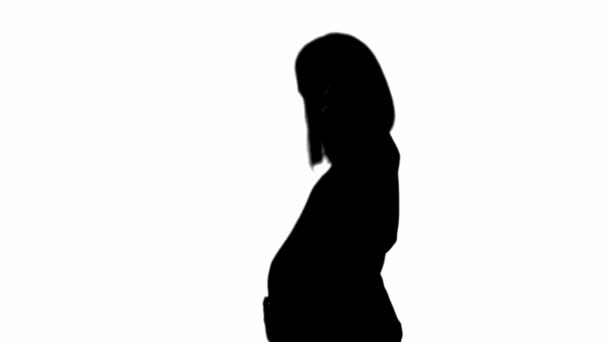 Silhouette Pregnant Woman Moving Touching Belly Isolated White — Stock Video