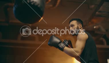 Punç çantası ile boks eldiven eğitimi kas boksörün düşük açı görünümü